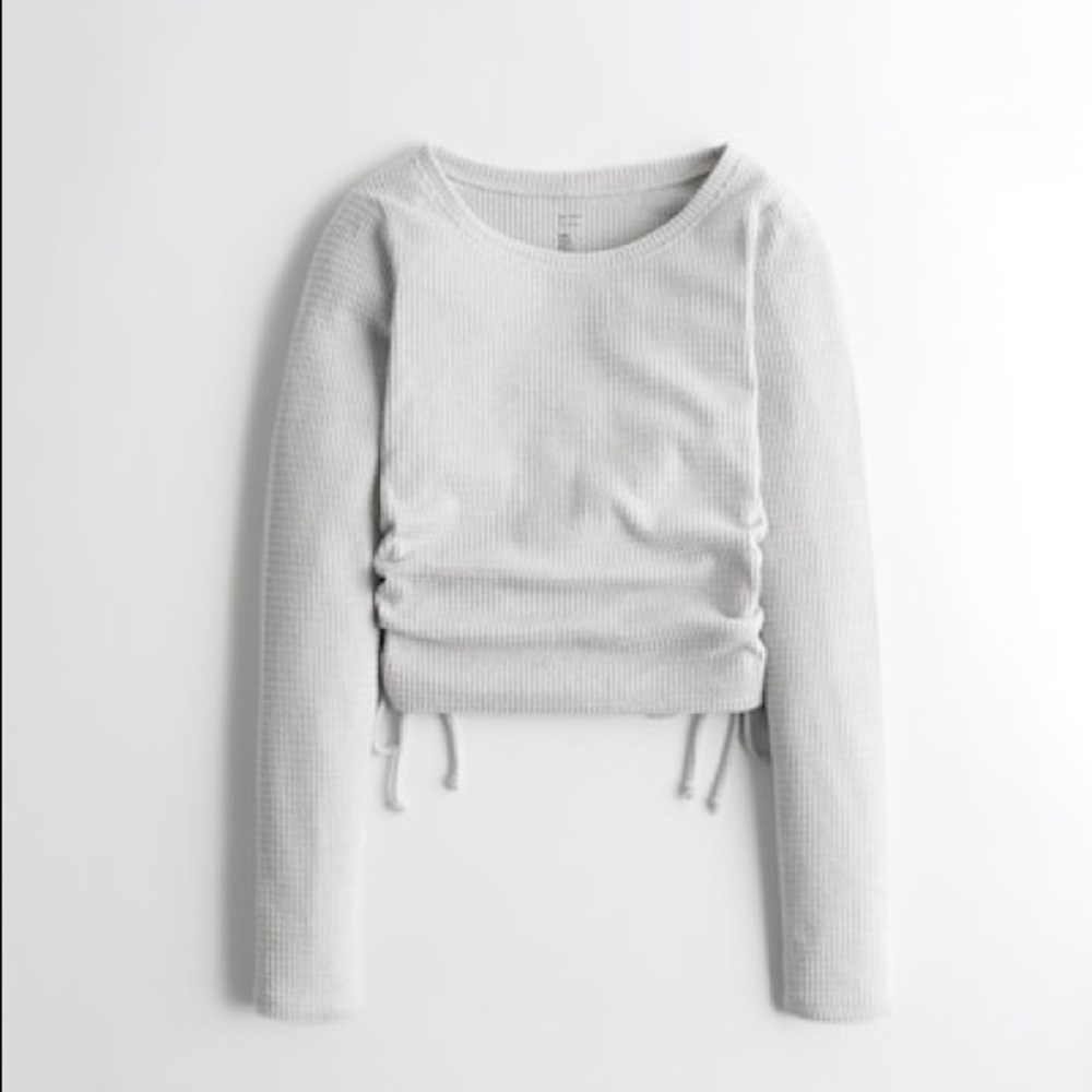 Hollister super soft waffle knit sweater with scrunched and ties on the sides.
